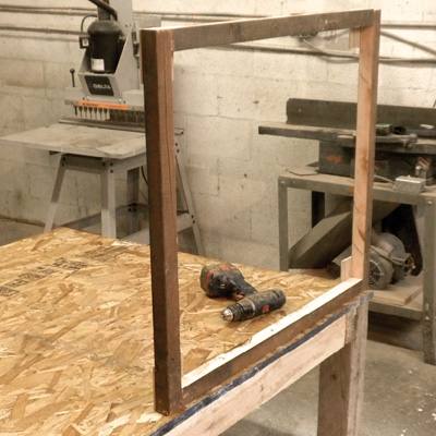 Attach the side wall panel frames to the base