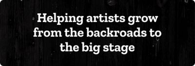 Helping artists grow from the backroads to the big stage. A banner with white text over a dark woodgrain background texture.