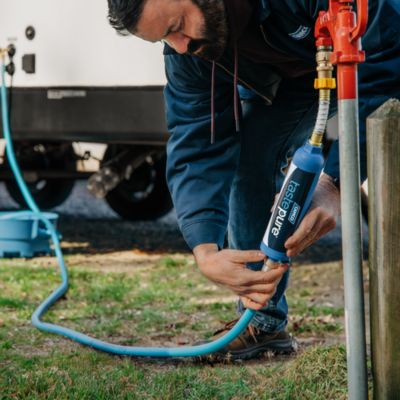 Image showing 7 th Camco TastePURE Water Filter with Flexible Hose Protector, 2-1/4 in. x 2-1/4 in. x 10 in., 100 Micron Fiber Filter