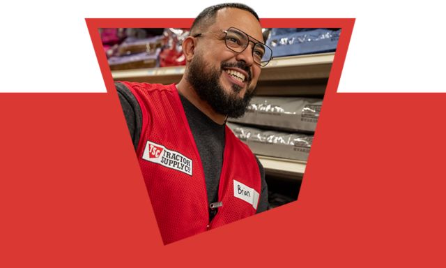 Tractor Supply Company banner featuring a team member in a red vest smiling in store. Text reads Got questions We are here to help. Our team members offer neighborly advice and a helping hand. Stop in and look for the friendly face in the red vest.