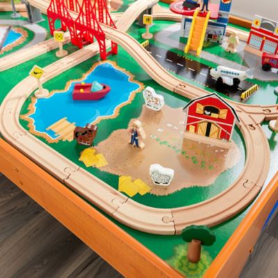 Image showing  Ride Around Town Wooden Train Set and Table with Storage Bins, Honey, 100 pc.
