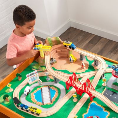 Image showing  Ride Around Town Wooden Train Set and Table with Storage Bins, Honey, 100 pc.