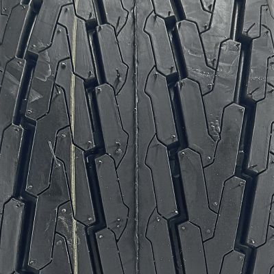 Image showing  20.5x8.0-10 (205/65D10) 6 Ply Highway Rib Tire and 4 on 4 Stamped Wheel Assembly