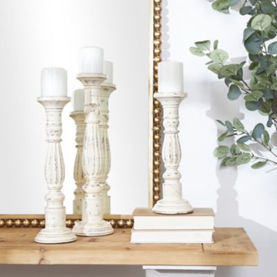 Harper & Willow Traditional Style Turned Column White Wood Candlesticks, 6 in. x 21 in., 5 in. x 17 in., 5 in. x 15 in., 3 pc.