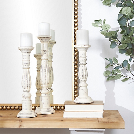 Harper & Willow Traditional Style Turned Column White Wood Candlesticks, 6 in. x 21 in., 5 in. x 17 in., 5 in. x 15 in., 3 pc.