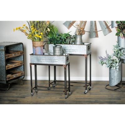 Harper & Willow 5 lb. Iron/Aluminum Farmhouse Planters with Wheels, 24 in./29 in., 2-Pack