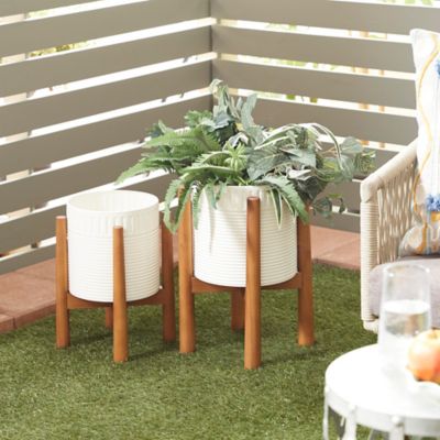 Harper & Willow White Metal Indoor Outdoor Planter with Removable Wood Stand Set of 2 17 in., 15 in.H