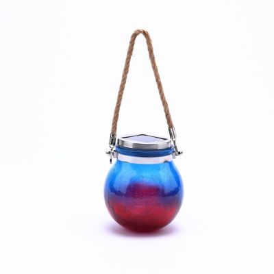 LuxenHome Blue and Red Crackle Glass Solar Outdoor Hanging and Table Lantern, WHSL1552 I hung it on a concrete statue figure that was missing his lantern and it's a perfect size