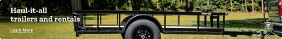 Promotional banner for Carry On trailers and rentals. Text reads Haul it all trailers and rentals. Learn more. Image features a black Carry On utility trailer hitched to a pickup truck on green grass with trees in the background.