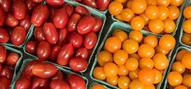 Fresh tomatoes displayed at a community market.