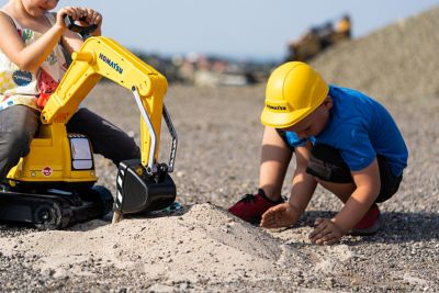 Image showing  Komatsu Crawler Excavator Ride-On with Opening Seat and Helmet, Ages 3 and Up, Yellow