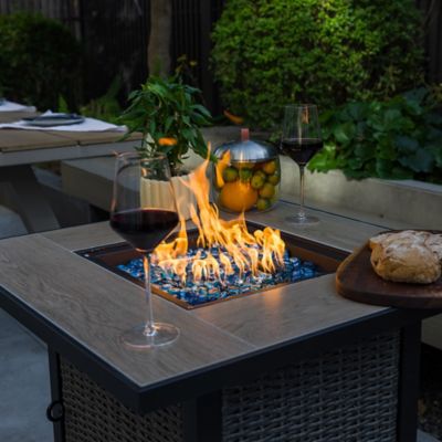 Image showing  30 in. Propane Fire Pit Table, 50,000 BTU Hand-woven Rattan Patio Gas Fire Pit with Lid & Blue Glass Bead