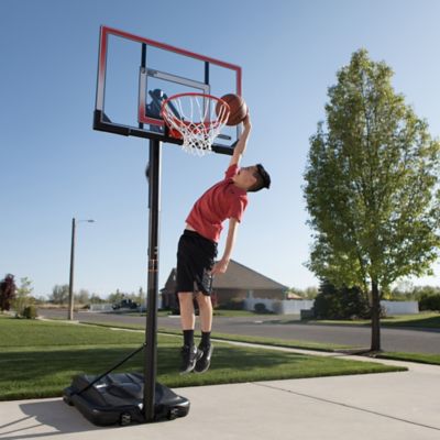Image showing 9 th Lifetime 50 in. Adjustable Portable Basketball Hoop, Red/Clear