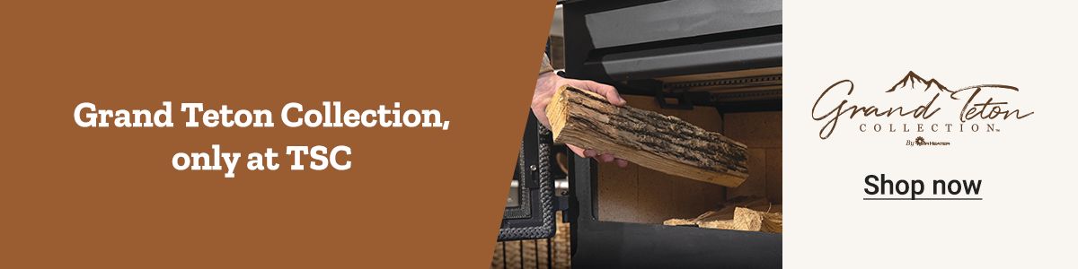 A wood log being added to a Grand Teton Collection heating stove