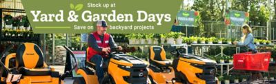Stock up at Yard & Garden Days promotion banner featuring a man riding a Cub Cadet lawn mower in a garden center, with additional riding mowers on display, plants and flowers in the background, and a shopper with a red cart browsing; text reads “Stock up at Yard & Garden Days – Save on backyard projects.