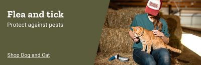 Flea and tick. Protect against pests. Shop dog and cat. Person wearing a Tractor Supply Company hat sitting in a barn beside hay bales while holding an orange cat.