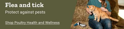 Flea and tick. Protect against pests. Shop dog and cat. Person wearing a Tractor Supply Company hat sitting in a barn beside hay bales while holding an orange cat.