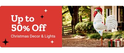 Holiday promotional banner showing up to 50 percent off Christmas decor and lights. The image features an outdoor Christmas display with a large white rooster statue wearing a Santa hat surrounded by wrapped gifts, set in a yard with trees and landscaping.
