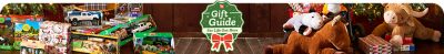 Holiday-themed promotional banner titled Gift Guide For Life Out Here featuring a green badge design with a red ribbon bow at the center. The background shows Christmas gifts under a decorated tree,including plush animals,toy trucks,and boxed toys. The warm lighting and rustic wooden floor create a cozy festive atmosphere highlighting holiday shopping ideas.